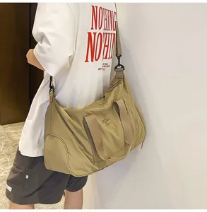 Khaki waterproof travel duffel bag detail showing large capacity, durable handles and adjustable strap.