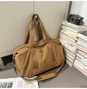 Large capacity waterproof duffel bag for travel, outdoor sports, gym, and student boarding use.
