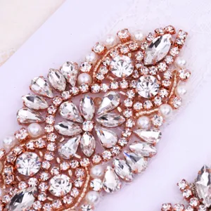 Exquisite rhinestone lace bridal thigh garter with rose gold details and sparkling crystal.