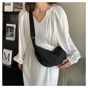 Detail view of the lightweight nylon crescent crossbody bag, chic black dumpling shoulder design.