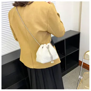 Detailed view of elegant white plush drawstring bucket bag featuring chic chain strap for daily wear.