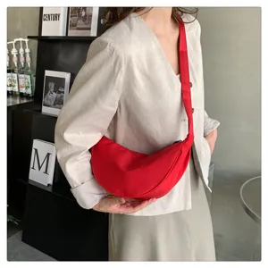 Red nylon crescent crossbody bag detail, casual lightweight half-moon shoulder bag.