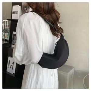 Black nylon crescent shoulder bag, casual lightweight dumpling crossbody purse for daily use.