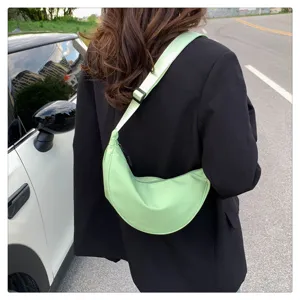 Light green nylon crescent crossbody shoulder bag detail, casual daily commuter dumpling bag.