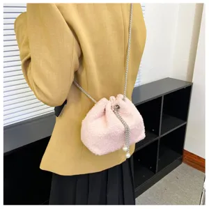 Pink plush drawstring bucket bag with chain strap and pearl decor for women daily use.