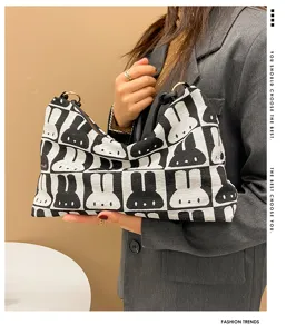 Detailed view of the black and white knit rabbit pattern shoulder bag worn by model, chic.