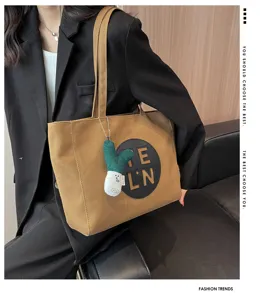 Casual canvas tote bag for women, large capacity shoulder bag with stylish embroidery design.