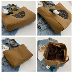 Korean style large capacity washed canvas tote bag with shoulder strap and stylish letter patch.