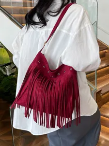 Wine red suede fringe shoulder bag detail, boho style crossbody purse, chic daily wear item.