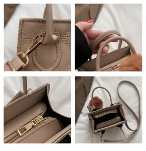 Detailed view of trendy niche design women handbag, chic stitching, metal zipper, shoulder strap.