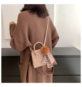 Chic quilted crossbody bag with furry pom-pom and patterned scarf for women daily commuting style