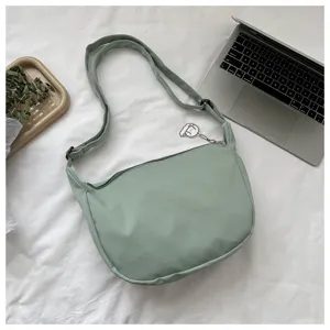 Waffle texture dumpling shoulder bag, simple casual crossbody bag for women daily fashion use.