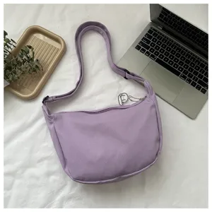 Purple waffle dumpling bag detail view, casual fashion crossbody shoulder bag for women.