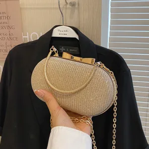 Elegant gold glitter evening clutch bag with bow clasp and chain strap for women parties.
