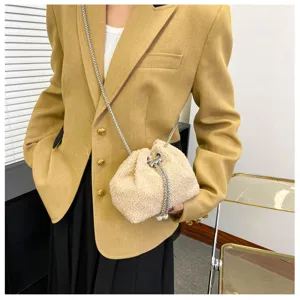 Fluffy plush drawstring bucket bag for women, chic crossbody chain handbag in beige.