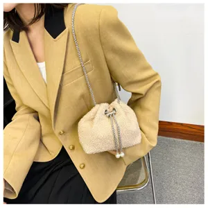 Fluffy plush drawstring bucket bag with chain strap, soft crossbody winter handbag detail.