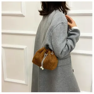 Brown plush bucket bag with chain strap and pearl details, soft furry texture detail.