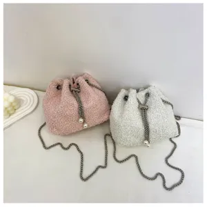 Plush drawstring bucket bag detail showing soft pink and white fuzzy texture with chain strap.