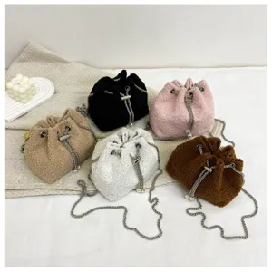 Detail view of fluffy plush drawstring bucket bags in multiple colors with chic chain straps.