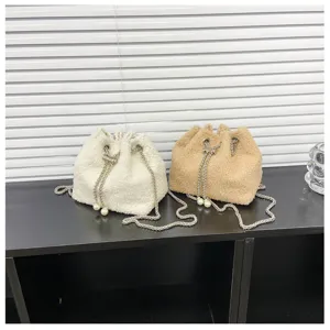 Detail view of plush bucket bag showing fluffy texture and chain strap in dual color options.