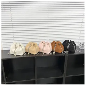 Stylish plush bucket bag with fuzzy texture, elegant pearl chain strap and secure drawstring closure.