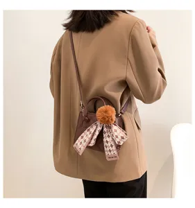 Chic minimalist crossbody tote bag with plush pom-pom and ribbon for women daily commute style