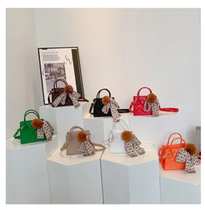 Stylish quilted mini tote bag with furry pom pom and chic scarf ribbon for women daily use.