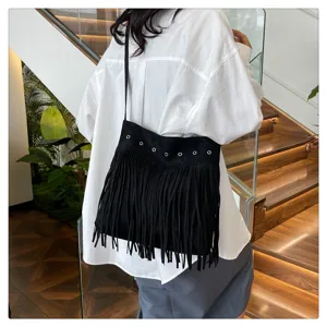 Black fringe crossbody bag for women, stylish suede shoulder bag with metal eyelet details.