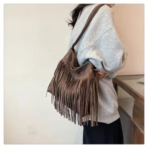Brown fringe shoulder bag for women, suede style crossbody bag with metal eyelet details.