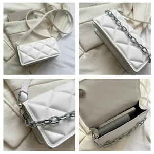 Detailed view of the stylish white quilted chain crossbody bag showcasing texture and chain strap.