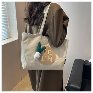 Stylish canvas tote bag for women, large capacity shoulder bag with cute cactus charm.