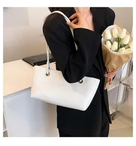 White patent leather shoulder underarm tote bag for women, stylish glossy commuting handbag.