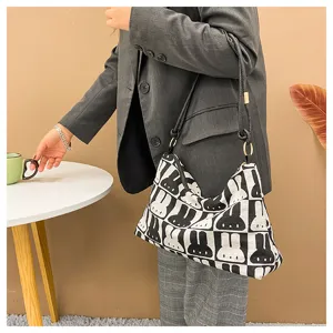 Canvas shoulder bag featuring a chic black and white rabbit pattern, large capacity for daily use.