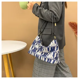 Canvas underarm shoulder bag with cute rabbit pattern, stylish daily casual bag detail shot.
