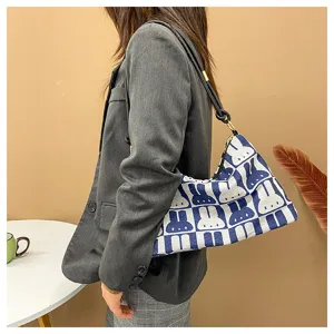 Canvas underarm shoulder bag featuring a trendy blue and white rabbit pattern design.