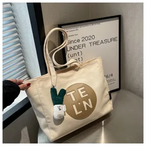 Women canvas tote bag large capacity shoulder handbag with letter embroidery and pendant detail view
