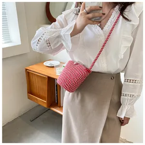 Charming red and white woven bucket phone bag detail, stylish crossbody accessory for daily wear.