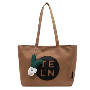 Brown canvas tote bag for women, large capacity shoulder handbag with cute plush charm.