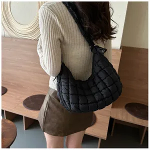 Stylish black quilted puffer underarm bag for women, trendy cloud shoulder bag design.