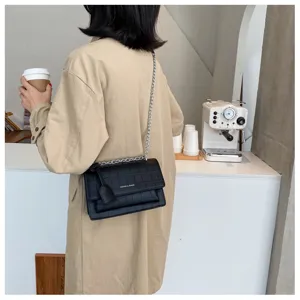 Women's stylish black stone pattern crossbody bag with chain strap and elegant flap design.