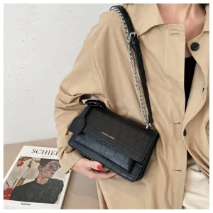 Black crocodile pattern shoulder bag detail, chic chain strap, fashionable daily accessory.
