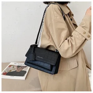 Black crocodile pattern leather shoulder bag detail, elegant chain strap and flap design.