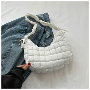 White quilted cloud shoulder bag detail showing soft padded texture and stylish gathered strap.