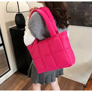 Pink quilted puffer tote bag detail, stylish winter soft shoulder bag with spacious design.
