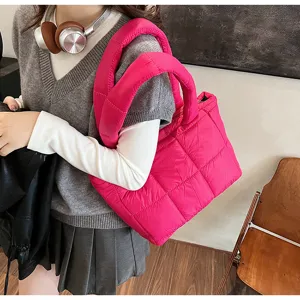 Trendy pink puffer tote bag for women, chic quilted design winter shoulder handbag.