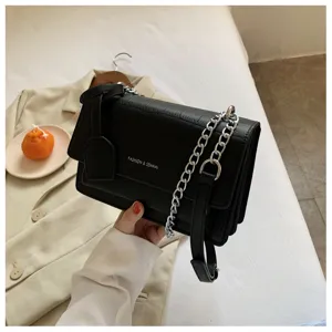 Black crocodile texture small shoulder bag with metallic chain strap and elegant crossbody design.