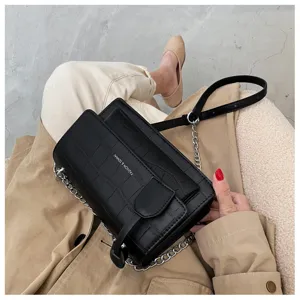 Women fashion black crocodile pattern crossbody bag, minimalist chain shoulder bag detail.