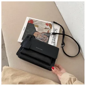 Chic black crocodile pattern women shoulder bag with stylish metal chain and flap closure design.