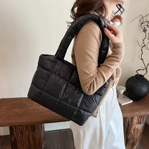 Chic black quilted puffer shoulder bag for women, stylish winter padded tote handbag for daily use.