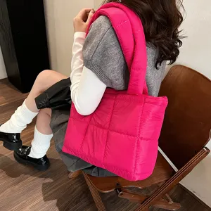 Pink quilted puffer shoulder bag, trendy women's padded underarm handbag for winter fashion.